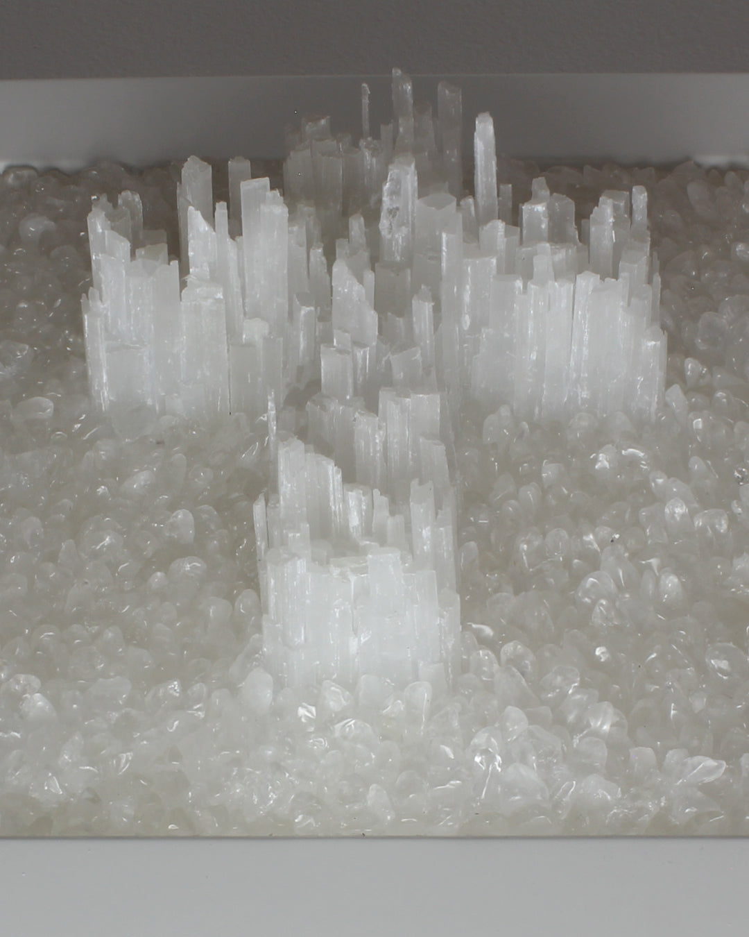 Delicate Selenite Crucifix on a bed of Clear Quartz